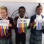Students holding up their work at Rookwood School, Wiltshire.