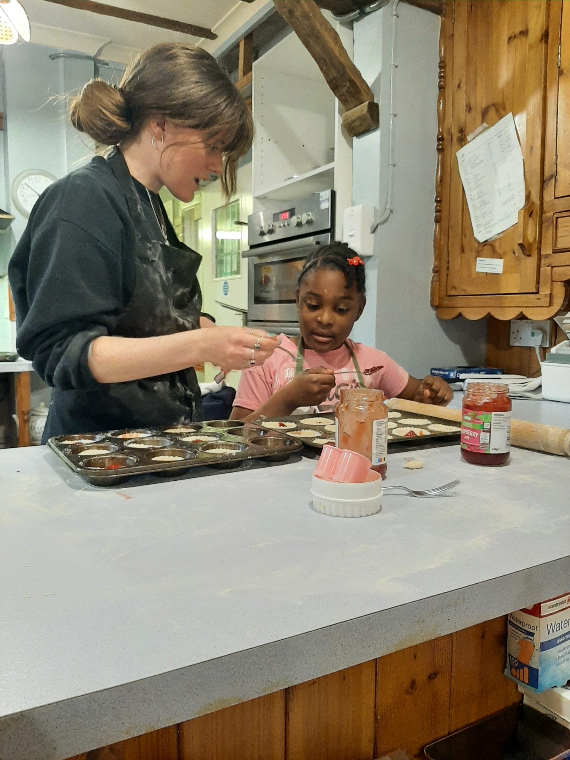 A young Rookwood boarding school student makes cakes in the kitchen with the boarding school staff.