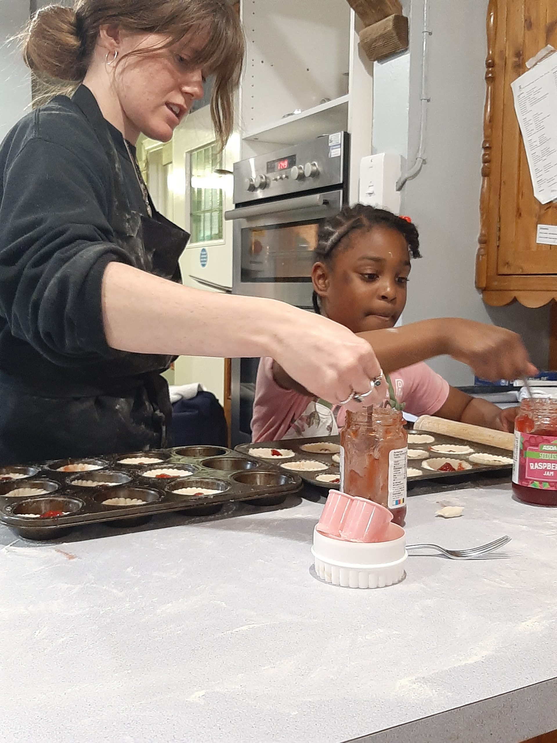A young Rookwood boarding student and boarding staff baking cakes in the boarding accommodation.