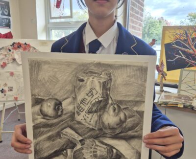 Student showcasing winning artwork