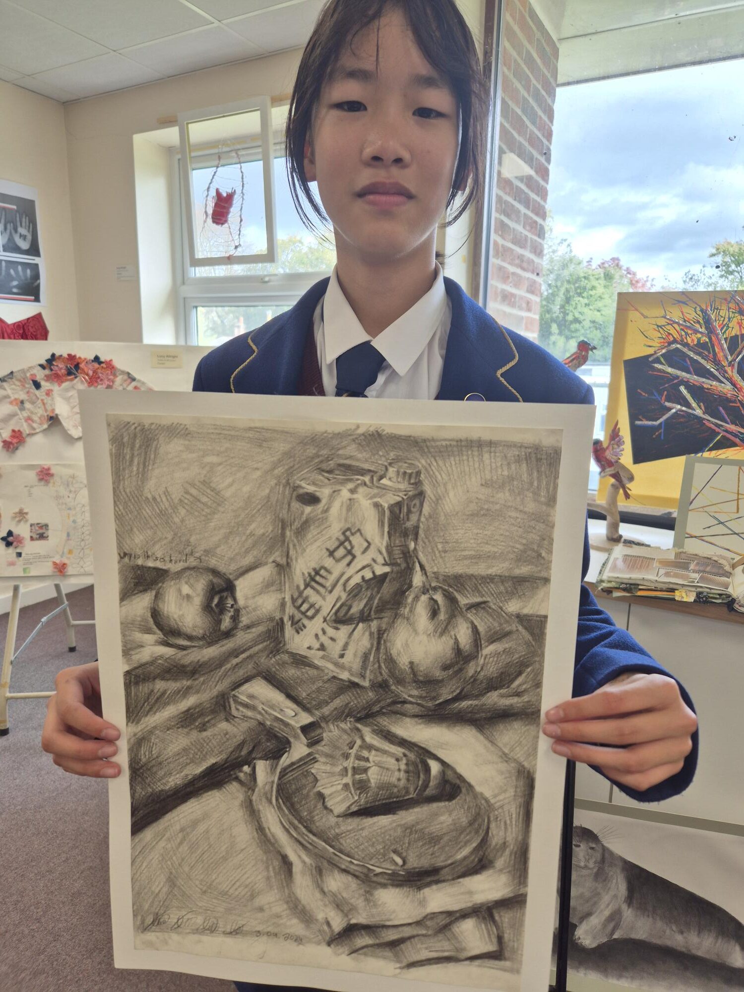 Student showcasing winning artwork