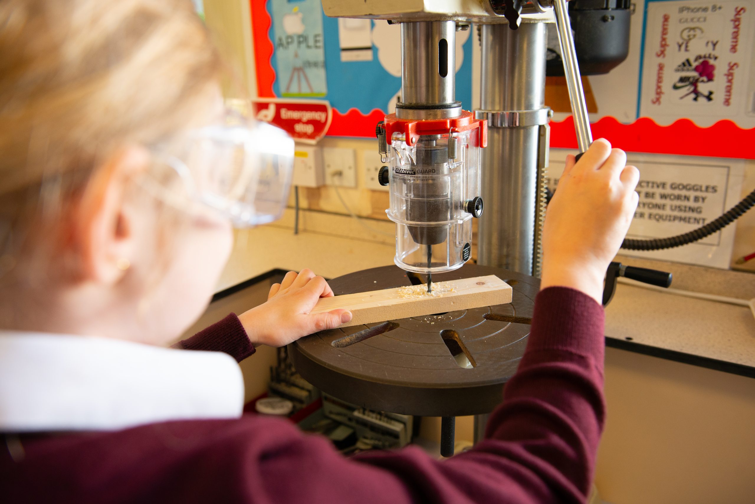 A Rookwood School student drilling a piece of wood in Design Technology class.