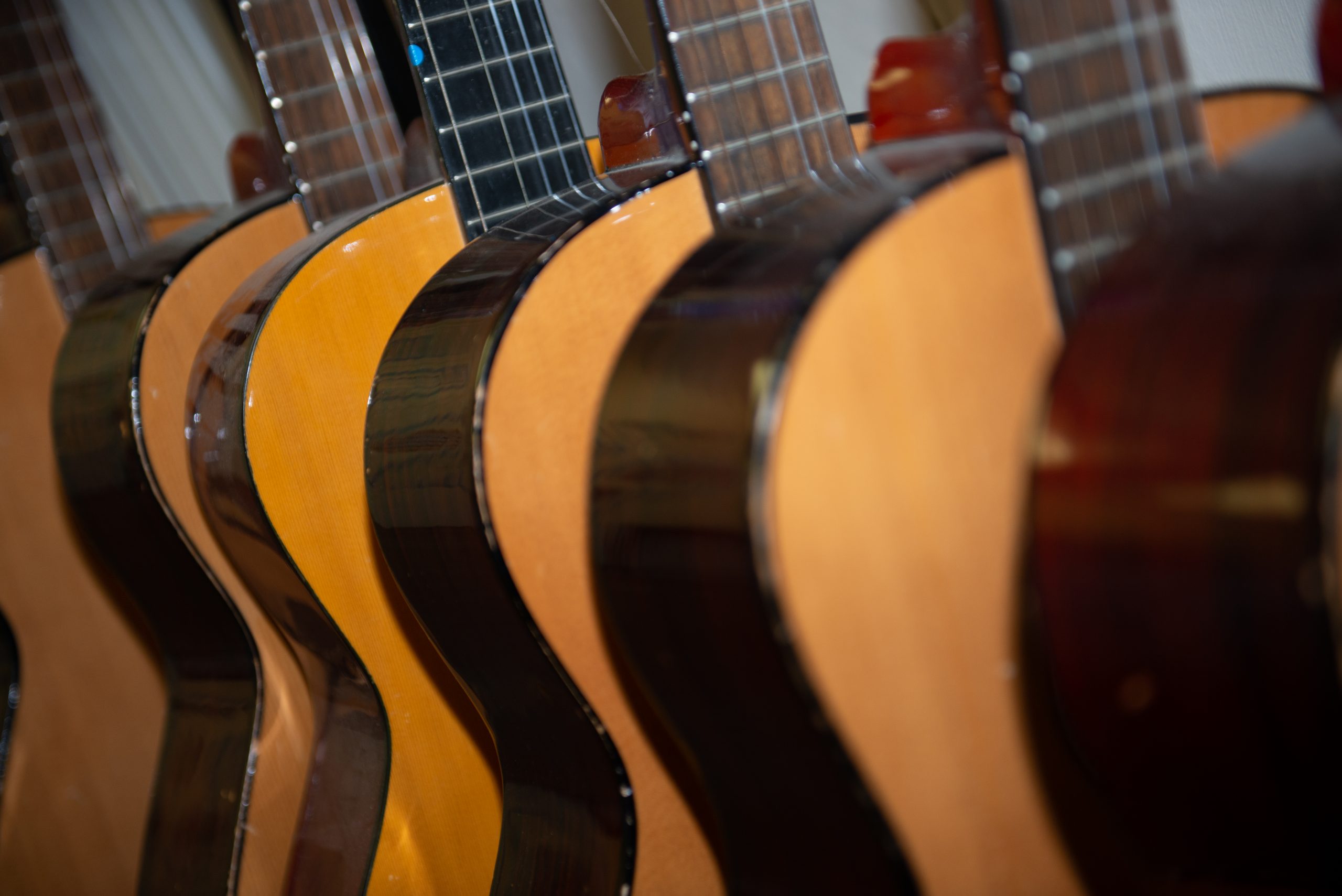Close up of guitars lined up in a music classroom in Rookwood Secondary School