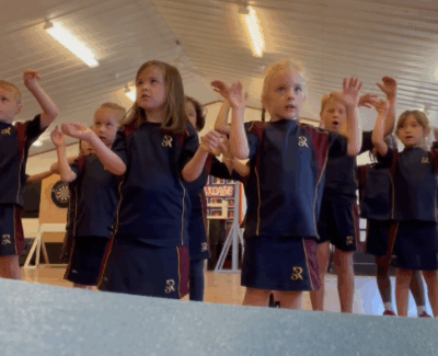 Children from different year groups signing the lyrics to "What a Wonderful World" in British Sign Language during Activity Week.