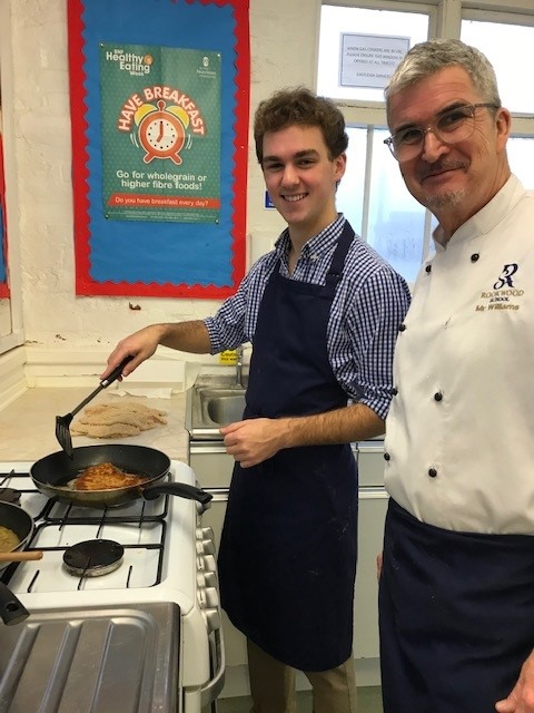 A student and staff member cooking healthy, filling food as part of an enrichment project at Rookwood School.
