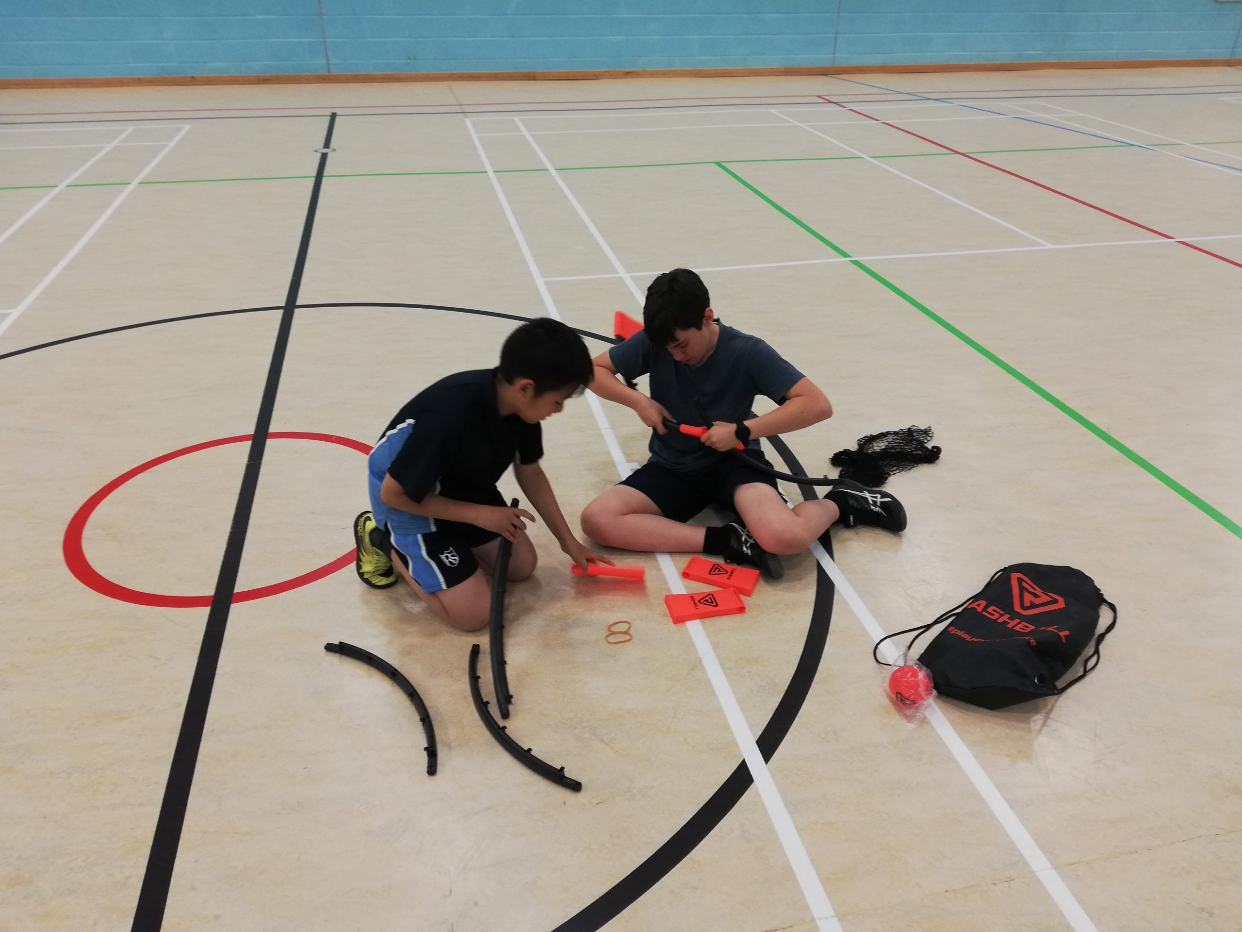 Rookwood School students setting up equipment in a sportshall.