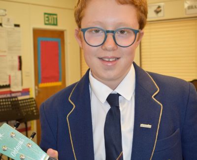 Student holding a ukelele at Rookwood Independent School.