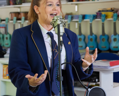 Pupil singing into microphone
