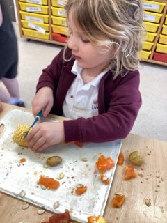 Child cutting a vegetable