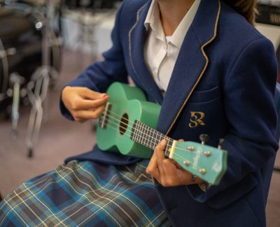 A Rookwood Prep School pupil playing the ukulele
