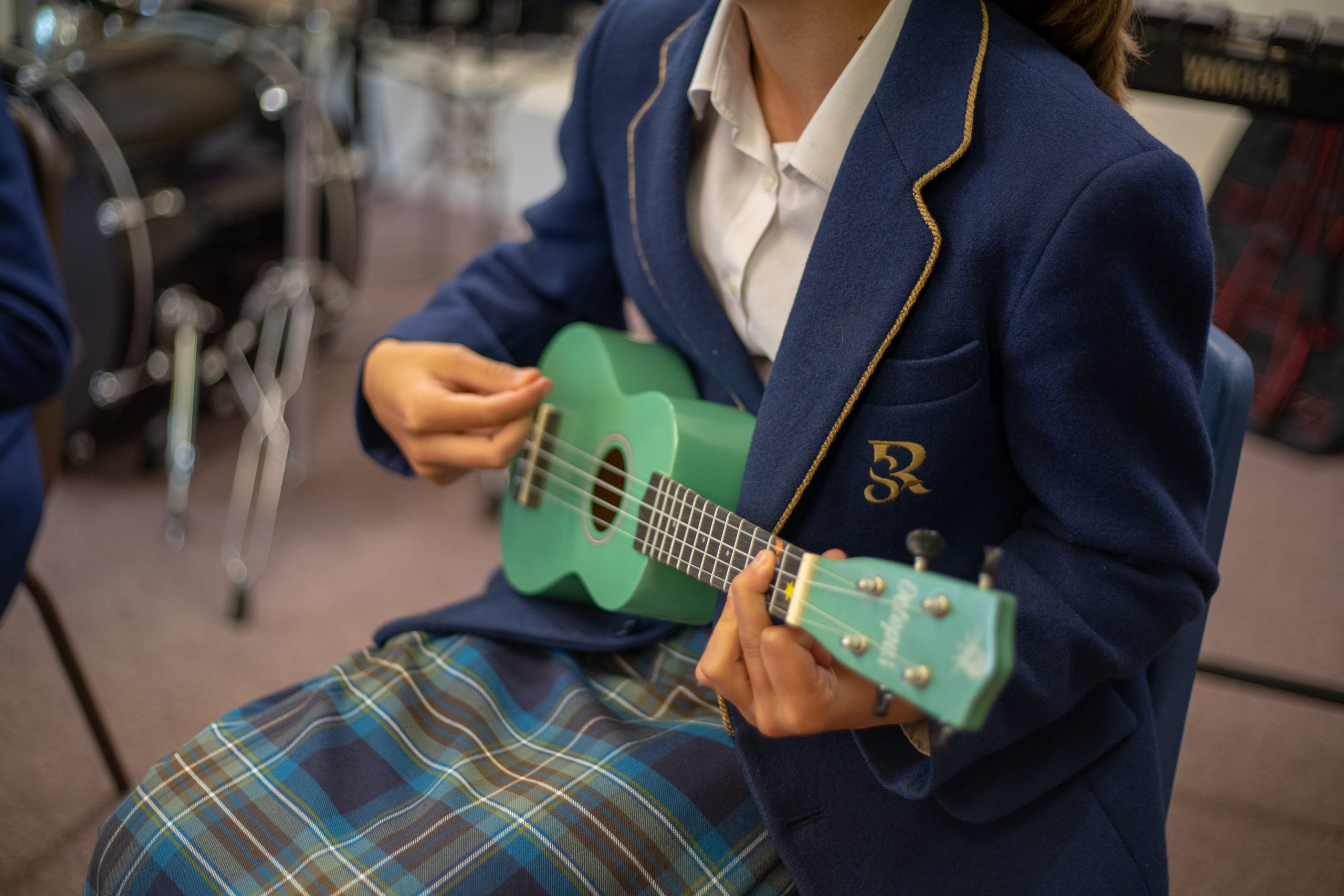 Rookwood School pupil playing the ukulele
