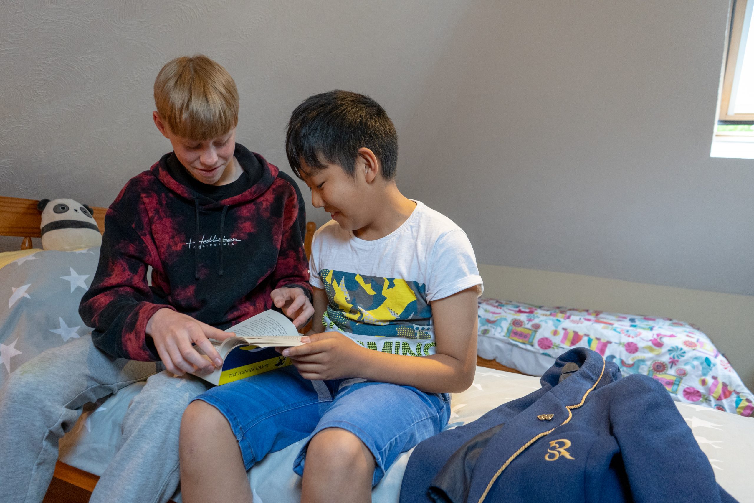 Two Rookwood boarding students are reading together in their bedroom.