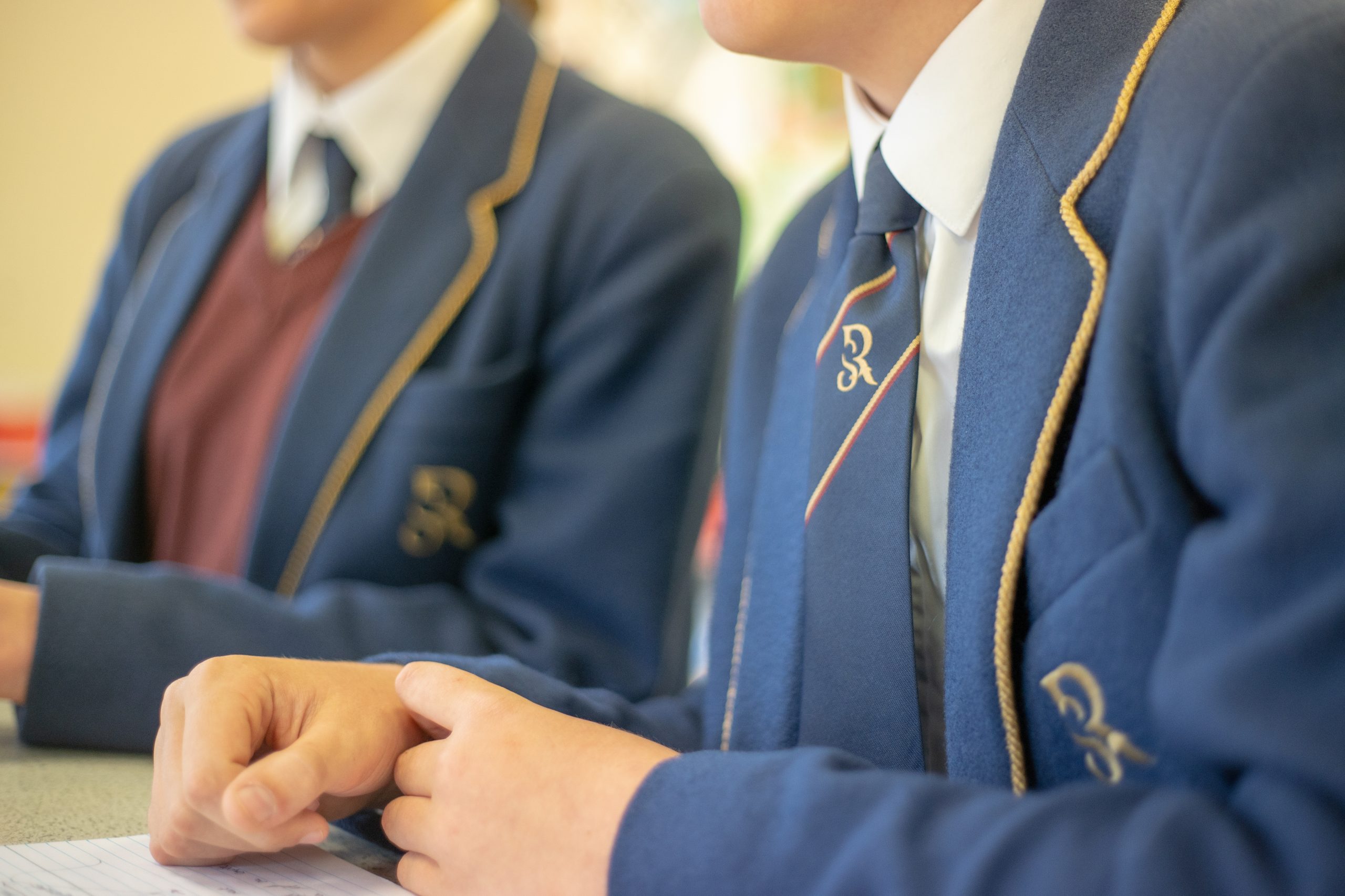 A close up of pupils wearing the Rookwood School uniform, worn by primary and secondary students.