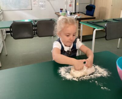 Reception child making bread