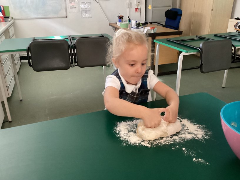 Reception child making bread