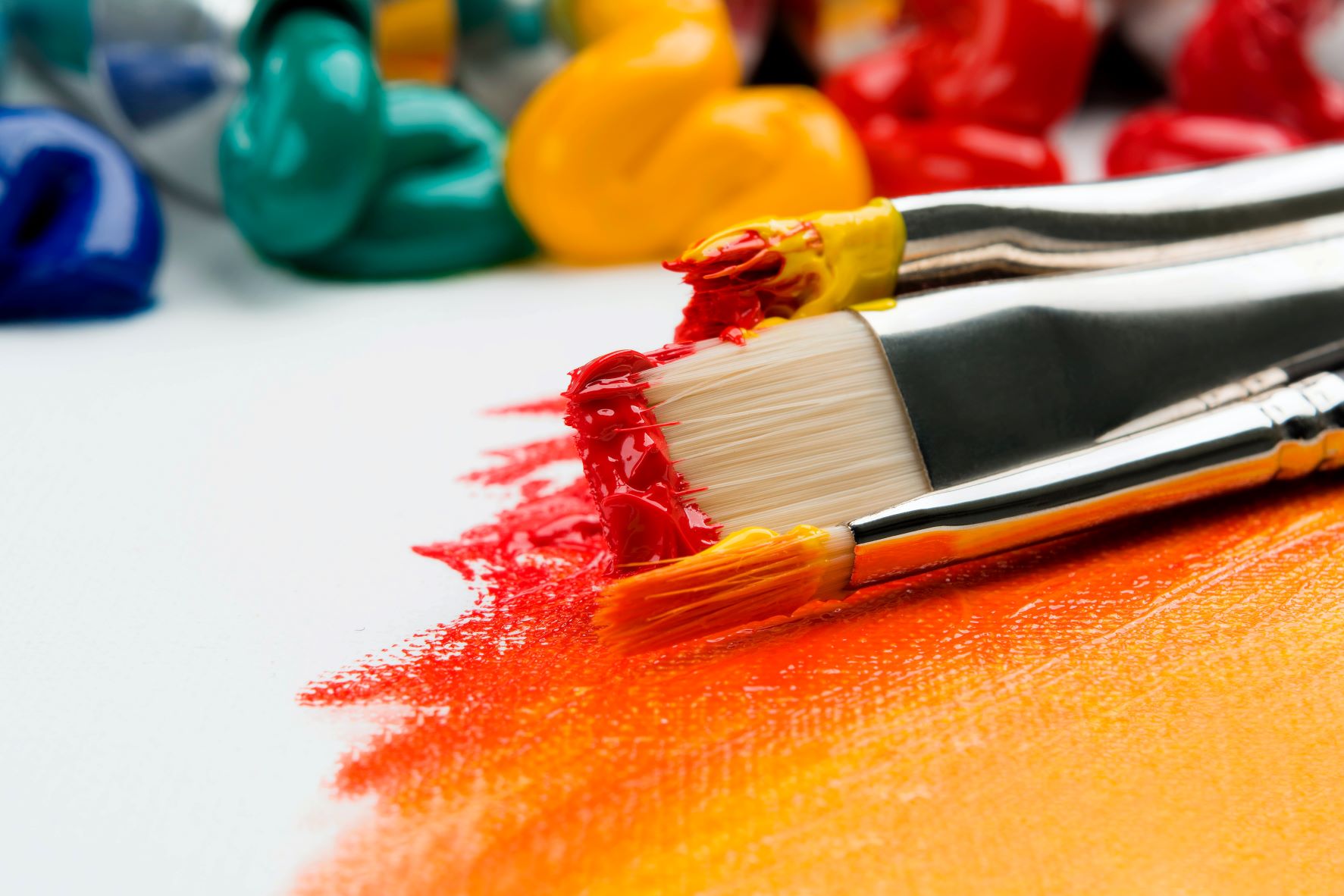 Paint brushes and paint on a canvas during a Rookwood School art lesson.