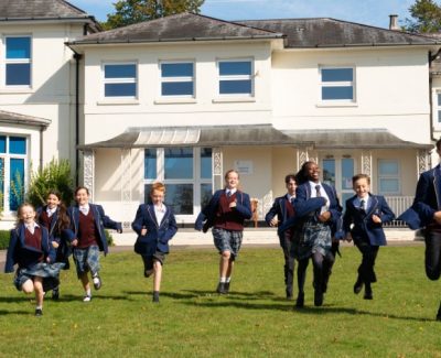 Students running in front of one of the buildings at Rookwood private school in Andover, Hampshire.