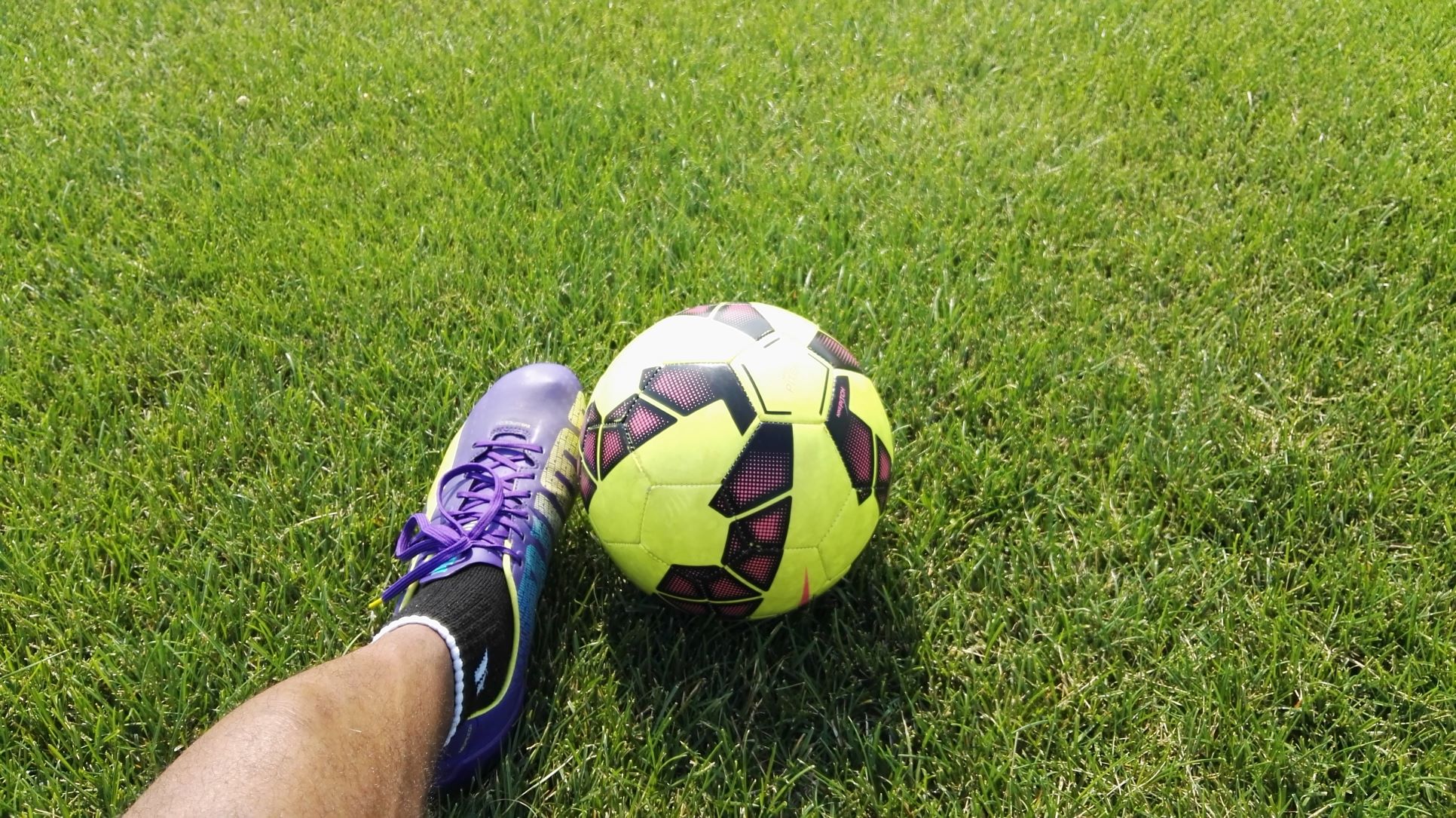 A close up of a Rookwood school student's foot kicking a football